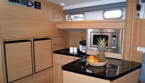 This 42's open-plan galley arrangement gives lots of space for fridge, freezer, microwave, and a dish washer under the high-gloss Corian countertop.