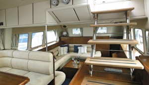 Looking aft from the helm position, showing the two seating/dining areas plus stairway to the flybridge